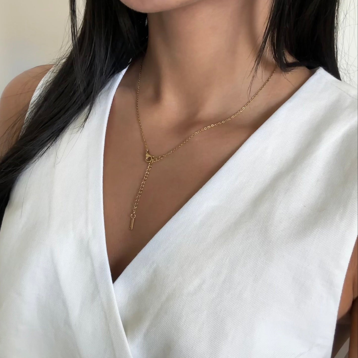 Model wearing Liora gold cross necklace – everyday waterproof jewelry