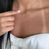 Side view of Serena necklace – single gold heart, elegant everyday jewelry

