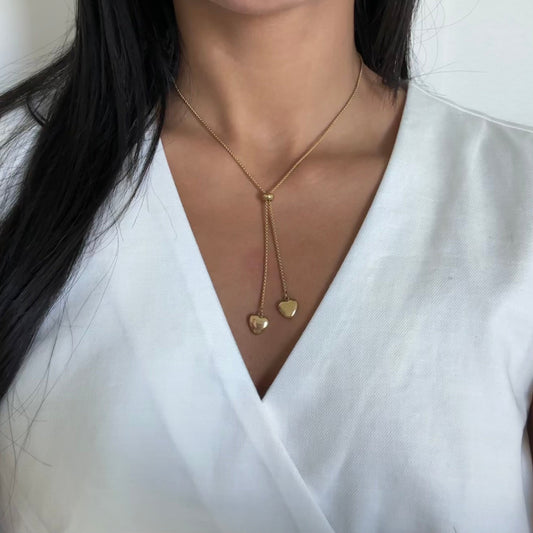 Close-up of two gold heart charms – Aria adjustable necklace

